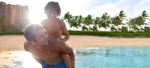 aulani-beach-listing-dad-holding-son-on-beach-top-sc